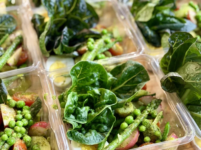 Leaf Water Farms romaine on a Niçoise salad with peas, asparagus and egg