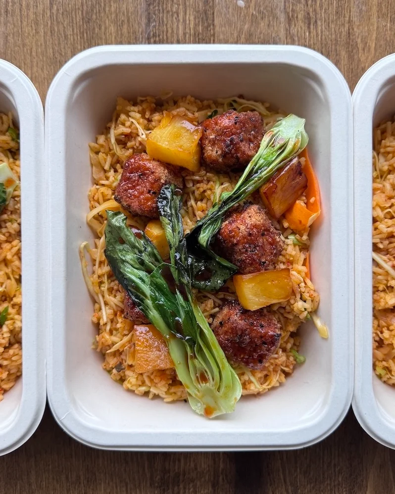 Korean cauliflower and kimchi fried rice with bok choy in a to-go container